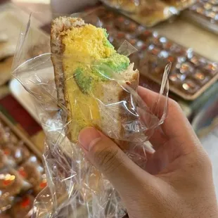 a person holding a piece of cake