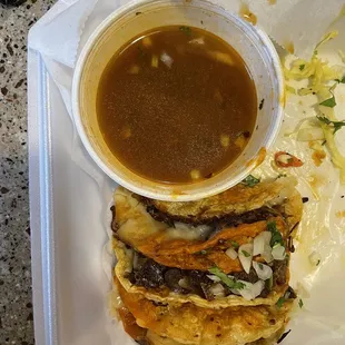 Birria tacos and consommé