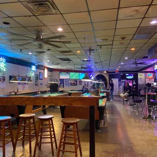 Shot of the standing bar/stools and counter by pool tables