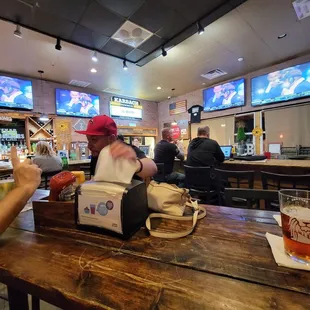 two men sitting at a bar