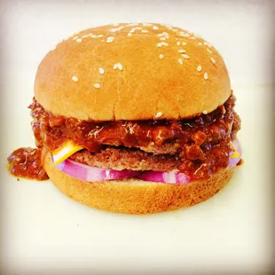 a hamburger with chili and cheese