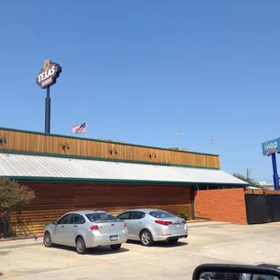 cars parked in front of a restaurant