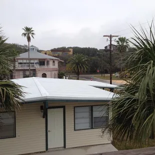 a view of a house and palm trees