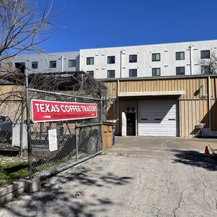 a sign on a fence in front of a building