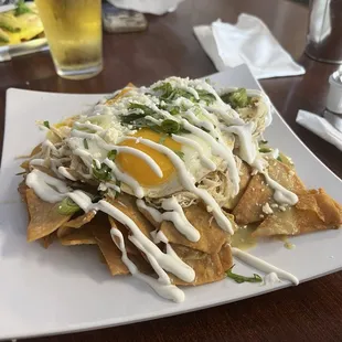 Green sauce chicken Chilaquiles with sunny side up eggs.