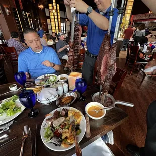 a man serving a meal at a restaurant