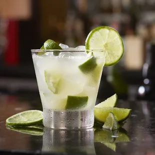 a close up of a drink with limes