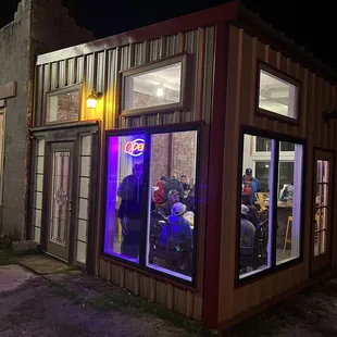 a group of people sitting outside at night
