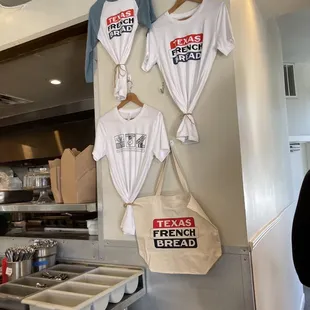 t - shirts hanging on a wall