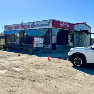 Exterior of building with casual seating and takeout option.