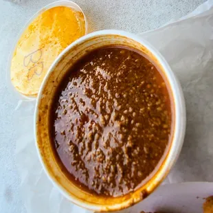 a bowl of chili sauce and a plate of fried chicken