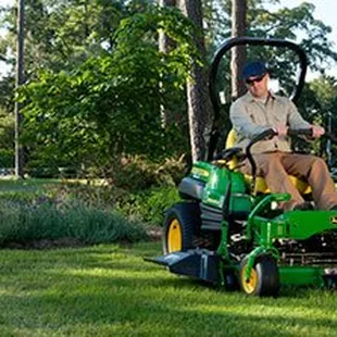 a man on a riding lawn mower