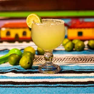 a margarita in a glass with a lime slice on the rim