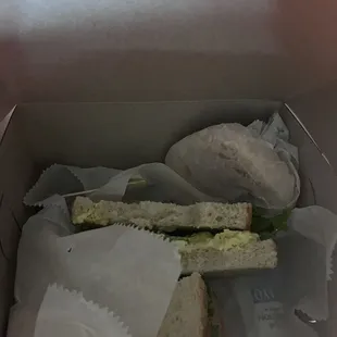 Egg Salad Sandwich on Sourdough  Snickerdoodle cookie wrapped in paper in the back right