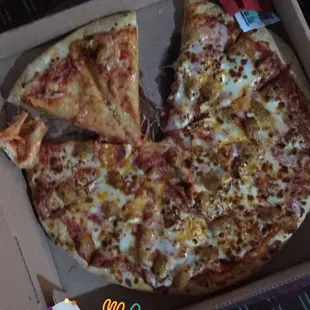 a pizza in a box with a slice missing