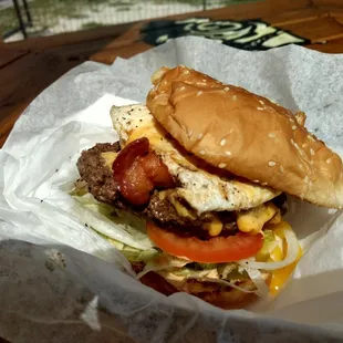  burger with bacon, lettuce, tomato, and cheese