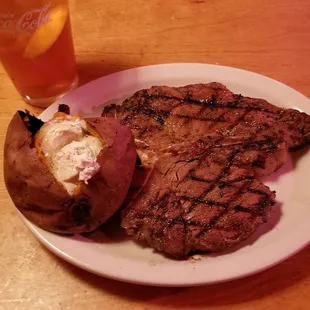 Texas Roadhouse in Racine, Wisconsin. 23 ounce Porterhouse with baked sweet potato. Awesome!