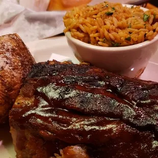 Ribs with baked potato and rice