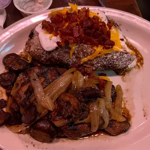 Smothered 8oz sirloin an' loaded baked potato.