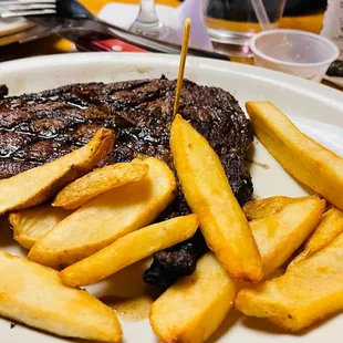 a plate of steak and french fries