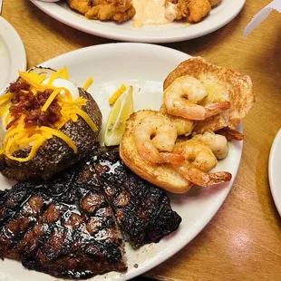 Loaded potato, well done ribeye and grilled shrimp