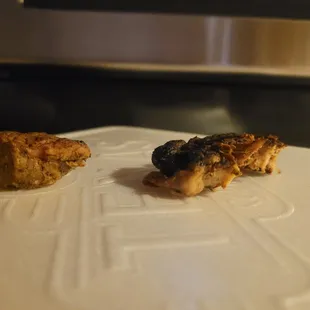 two pieces of chicken on a cutting board