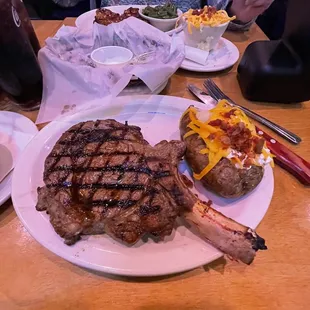 a large steak and a baked potato