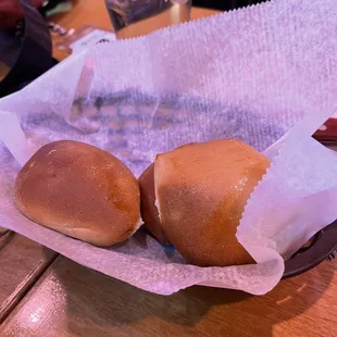 two buns in a basket on a table