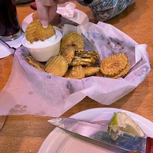 a person picking up chips from a basket