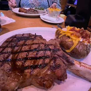 a large steak and a baked potato