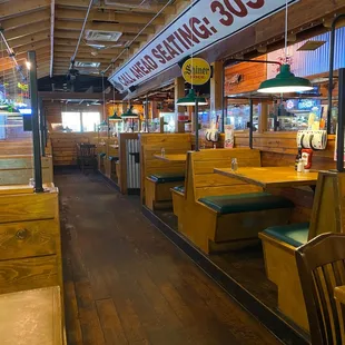 The rustic decor is wooden walls and seating.