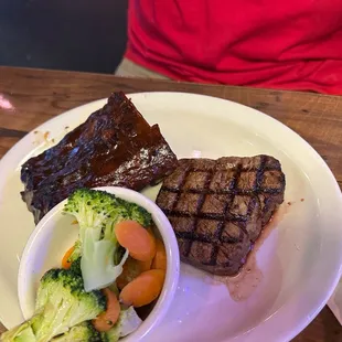 a plate of steak, broccoli, and carrots