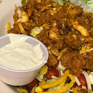 a bowl of taco salad with dressing
