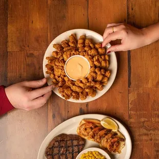 two plates of food on a wooden table