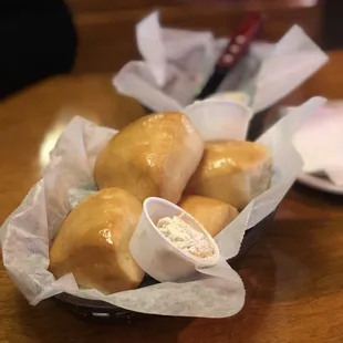 a basket of bread rolls on a table