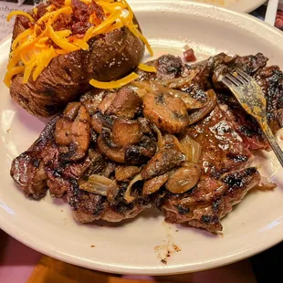 14 oz Fort Worth Ribeye with sautéed mushrooms and onions with a loaded baked potato