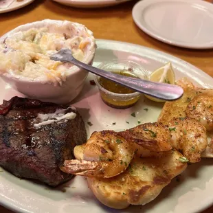 Steak and shrimp with loaded mashed potatoes.