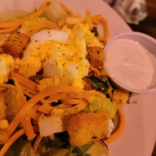 a plate of salad with dressing
