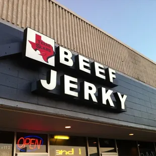 a beef jerky restaurant with neon signs
