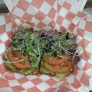 Avocado toast topped with tomato and micro greens
