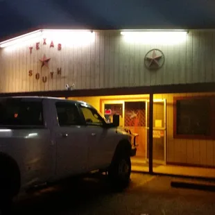 a white truck parked in front of a restaurant