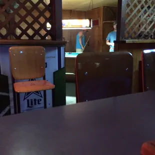 a bar with a pool table and chairs