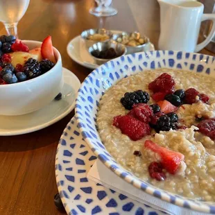 a bowl of oatmeal and a bowl of berries