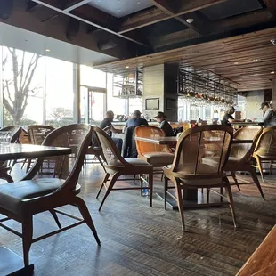 people sitting at tables in a restaurant