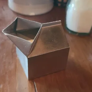 Cute metal milk dispenser shaped like a carton