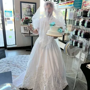 embarrassing lost bet man in wedding gown dress.  Mitch picking up wedding cake in wedding dress