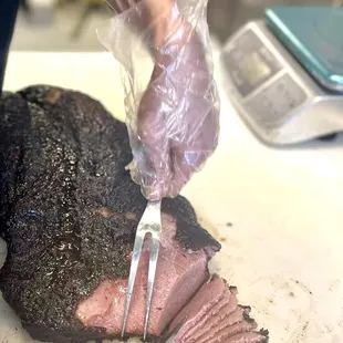 Slicing mouthwatering brisket at Texas Star BBQ, tender and juicy. Come taste the smoky perfection! Texas BBQ Brisket Slicing BBQ Ribs