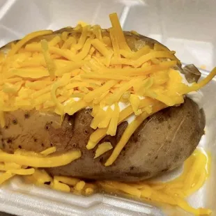 a baked potato covered in cheese