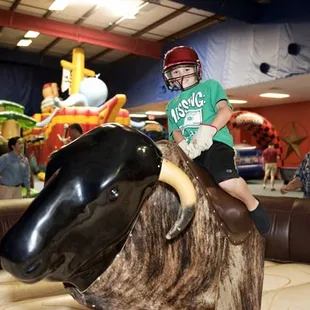 Games shown: Wild West Mechanical Bull, Wet/Dry Obstacle Course, Pirate Ship Adventure, and Kiddy Grand Prix.