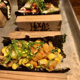 three sushi rolls on a tray